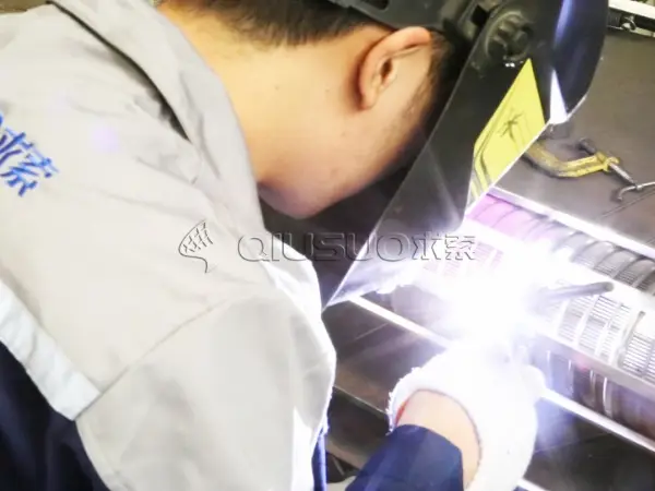 A working is welding frames of wedge wire filter basket.